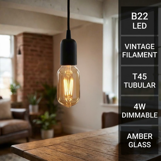 A hanging pendant light with a black socket and a glowing amber glass T45 bulb in a vintage filament design, shown in a softly blurred living room setting. A vertical text panel on the right lists features: B22 LED, VINTAGE FILAMENT, T45 TUBULAR, 4W DIMMABLE, AMBER GLASS.