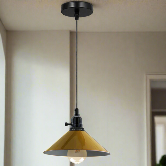 Pendant light with yellow glass shade and black metal fixture hanging from ceiling.