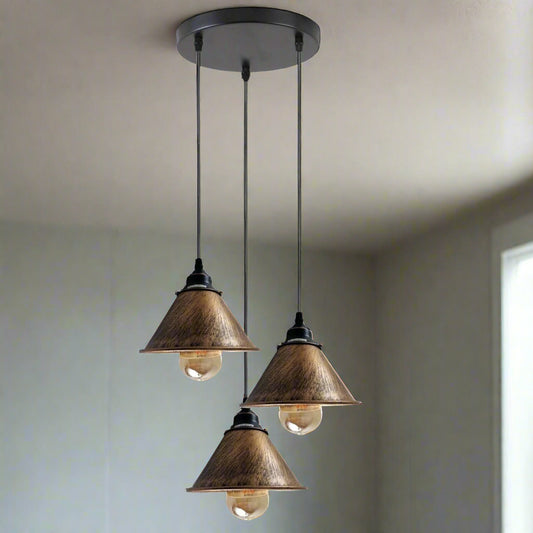 Three pendant lights with brown glass shades on a white background