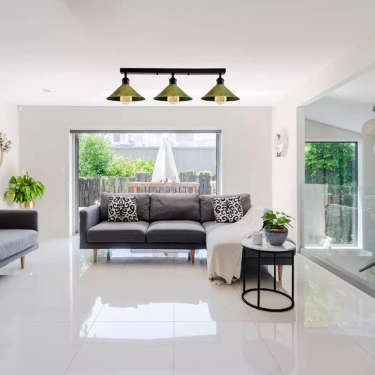 Modern living room with a gray sofa, decorative pillows, and a stylish light fixture.