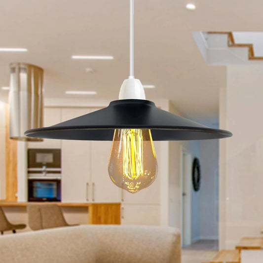 Black pendant light with a glowing yellow bulb in a modern kitchen setting