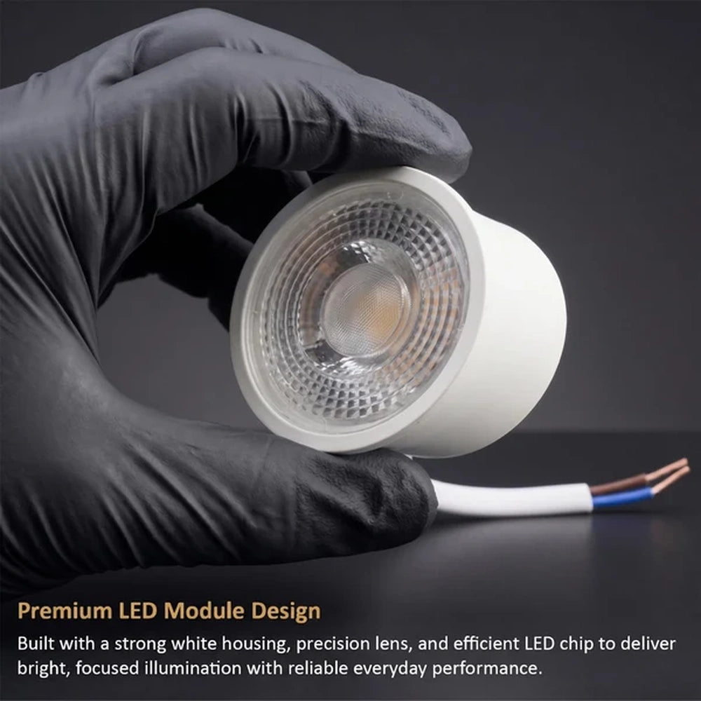 gloved hand holding a 7W COB LED module with white cable