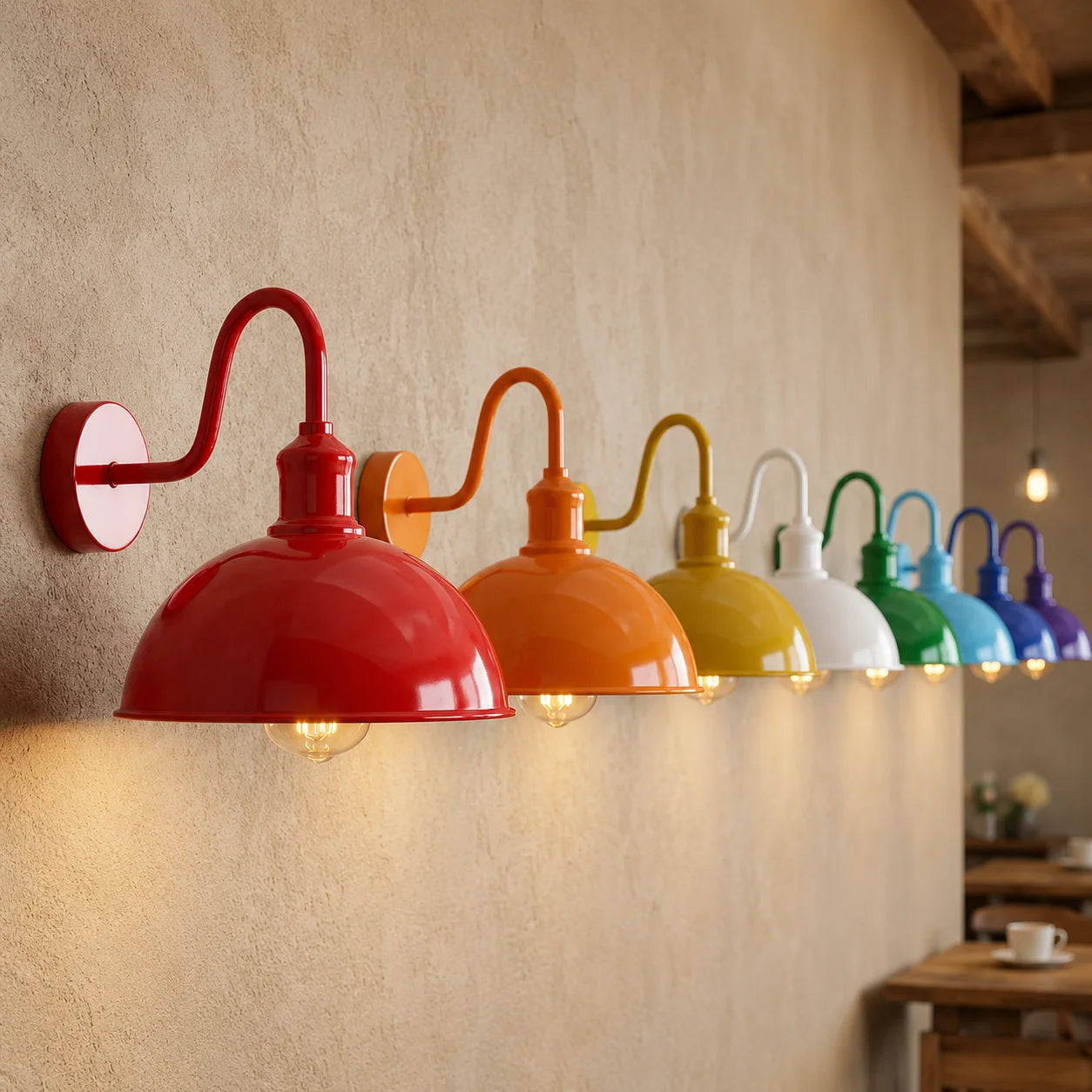 A row of colorful industrial-style wall sconces mounted on a textured beige wall, with warm bulbs glowing. The shades come in red, orange, yellow, white, green, blue, purple, and pink, arranged in a diagonal line.