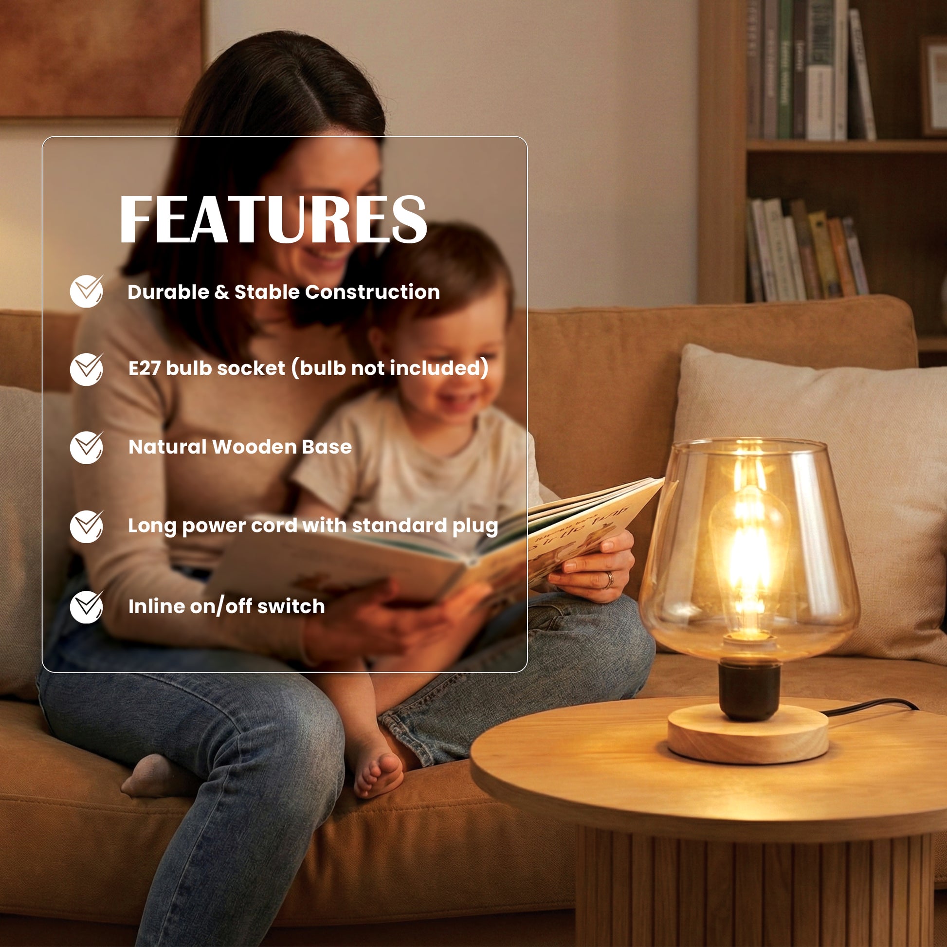 Woman and child reading a book together with a table lamp on a wooden table in the foreground.