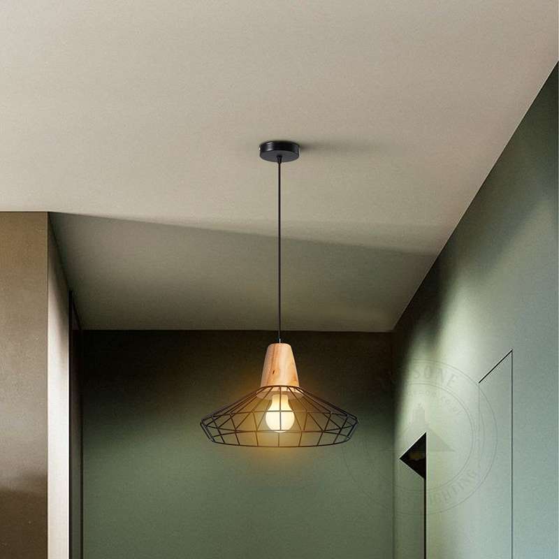 Modern black cage pendant light hanging in a stylish kitchen interior