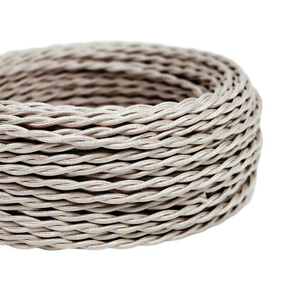 Coiled beige fabric cable on a white background