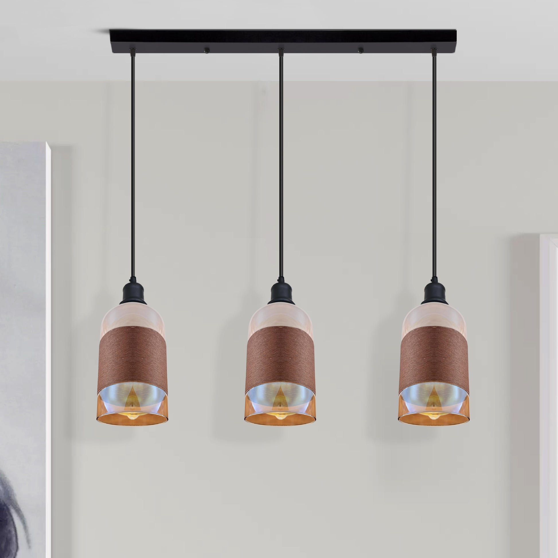 Three pendant lights with brown and white design on a neutral background