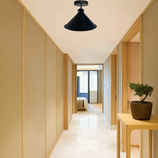 An industrial-style black cone shade flush mount ceiling light fixture is prominently featured on the ceiling of a modern hallway.