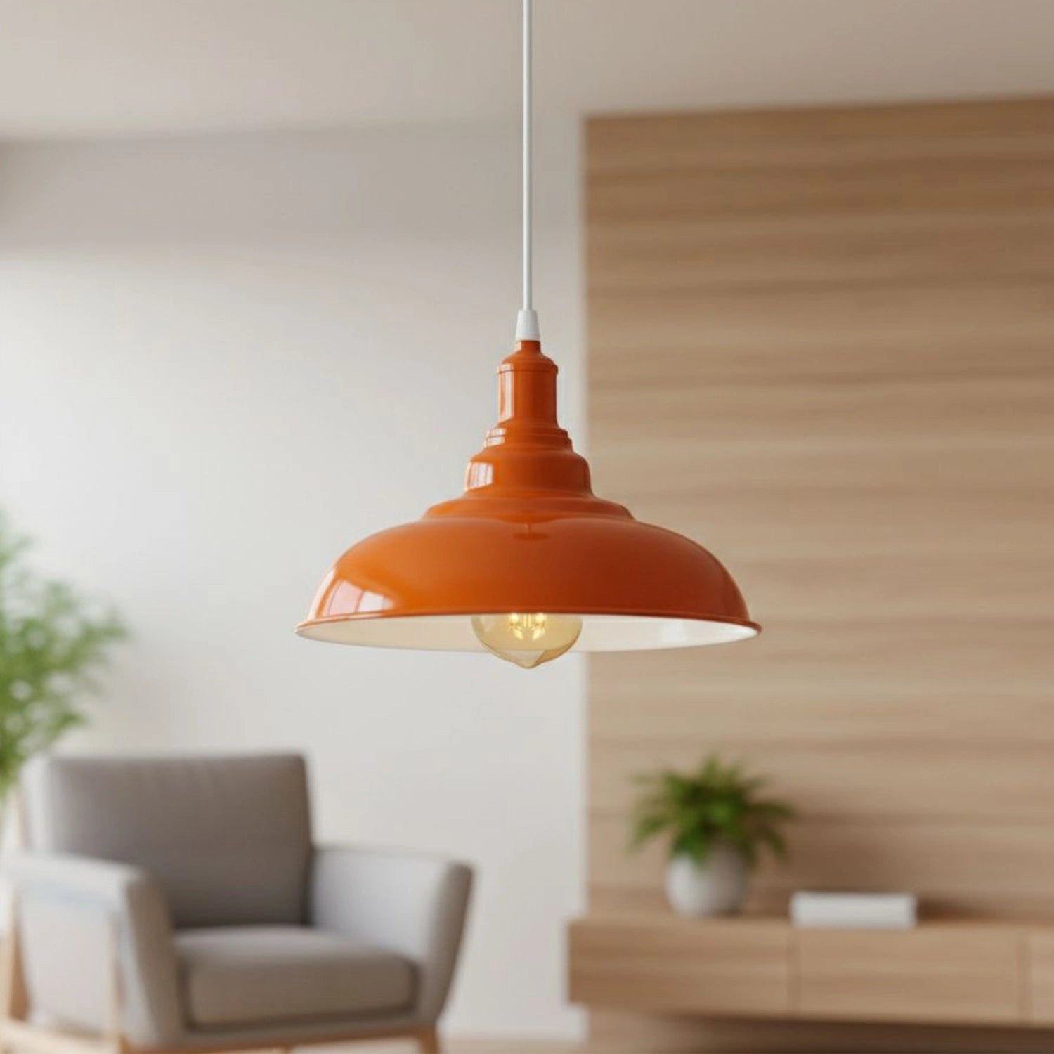 Orange pendant light hanging in a room with a blurred background