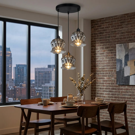 Dining room with wooden table, chairs, and pendant lights in front of a large window with cityscape view.