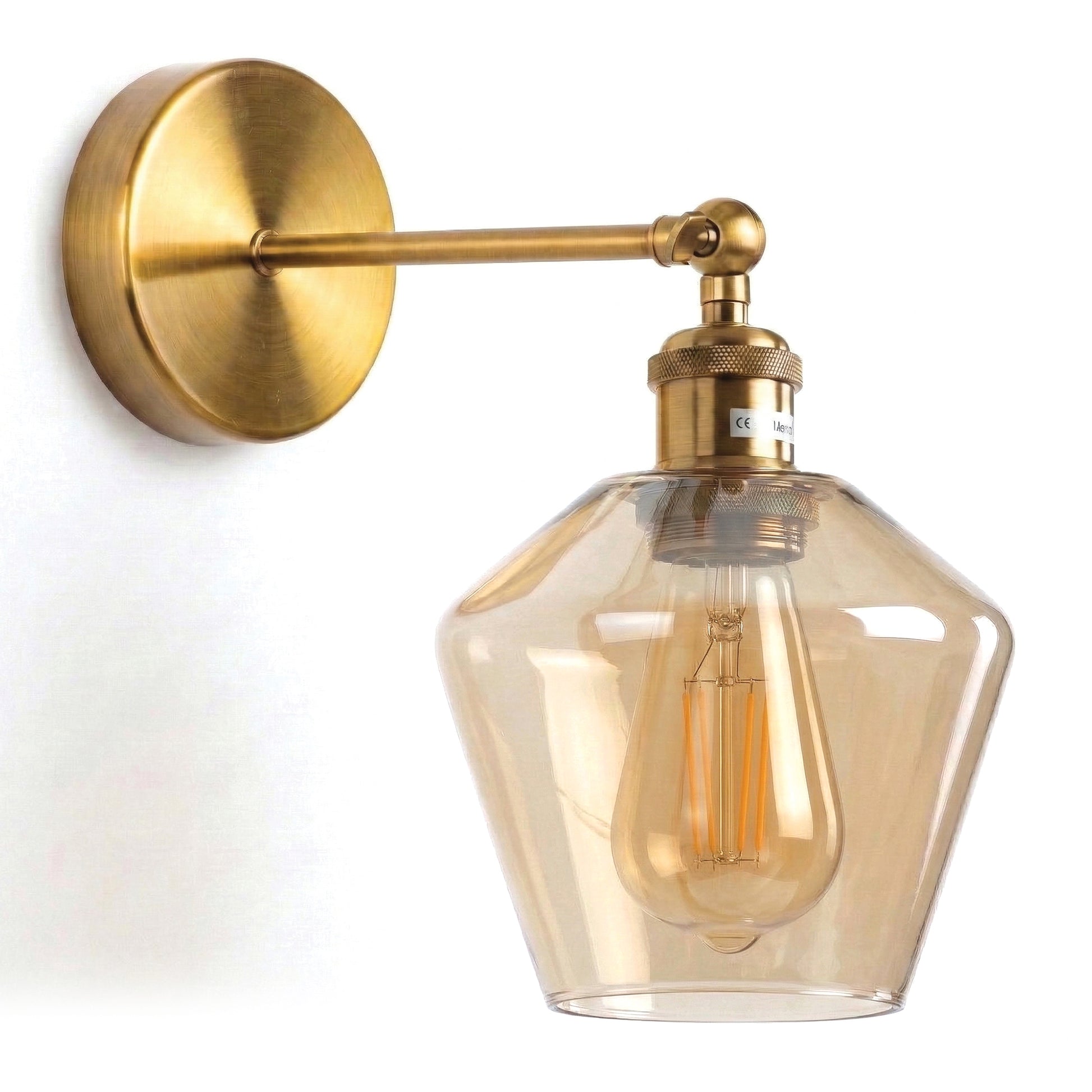 A modern industrial-style wall sconce featuring a circular brushed-brass mounting plate and a straight, horizontal support arm. 