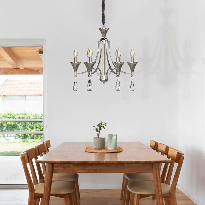 Ornate chandelier hanging above a dining room table.