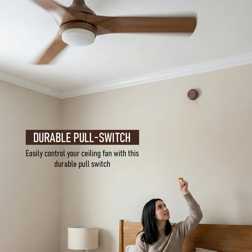 woman pulling a ceiling fan pull switch on a bedroom wall