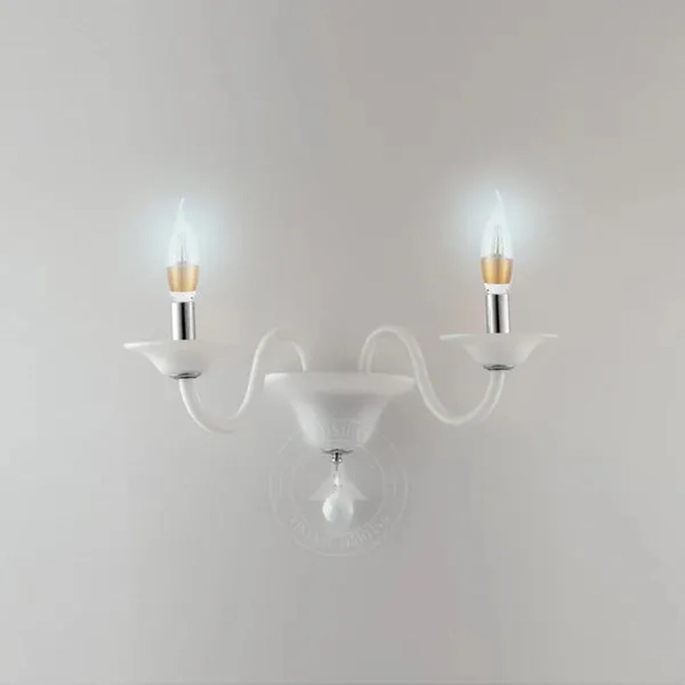 white wall light with two glowing LED candle bulbs