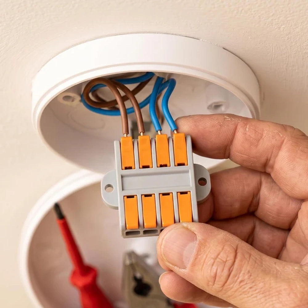 hand holding a lever wire connector inside a ceiling rose