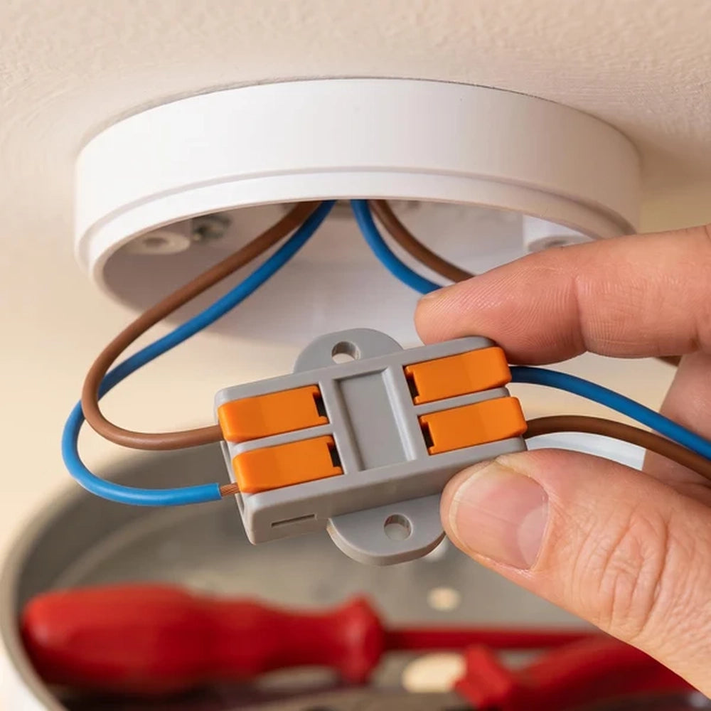 hand fitting a lever wire connector inside a ceiling rose