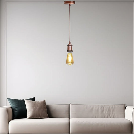 Pendant light fixture hanging above a sofa with a plain wall background