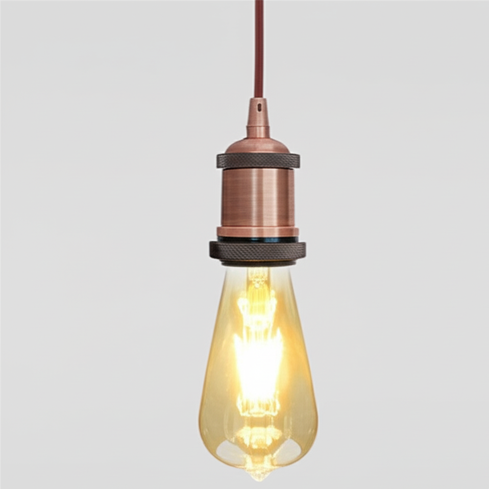 Vintage-style light bulb with copper fixture on a gray background