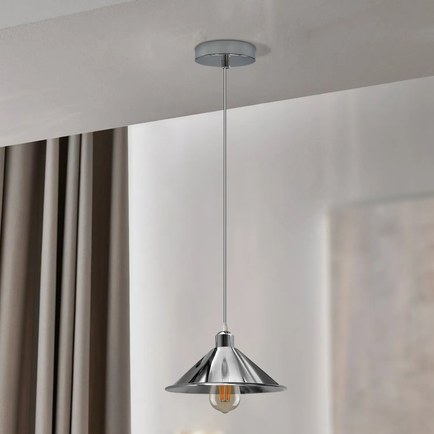 Silver metal pendant light hanging over kitchen island