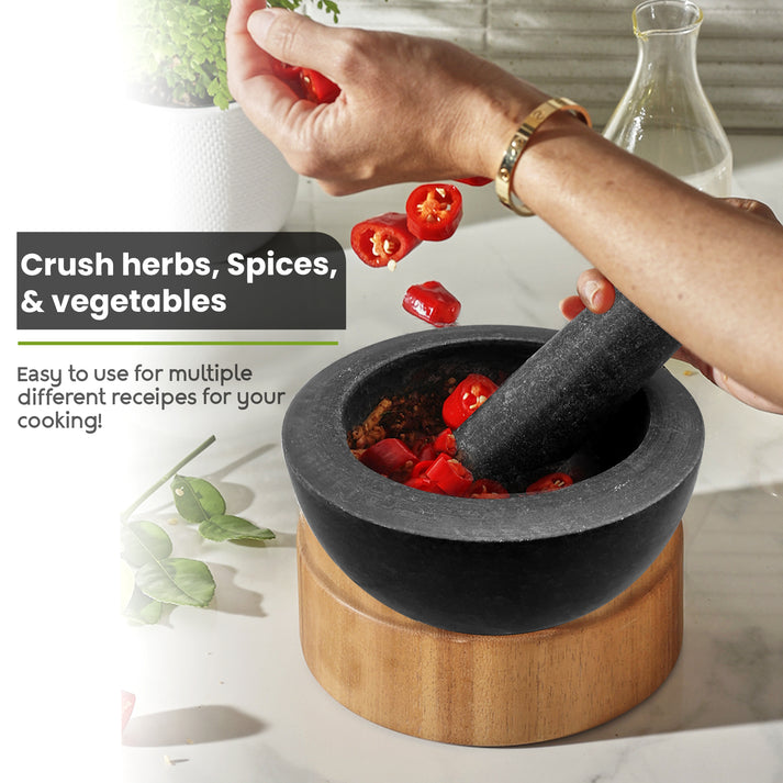 A stylish pestle and mortar set shown as part of a kitchen's accessories.