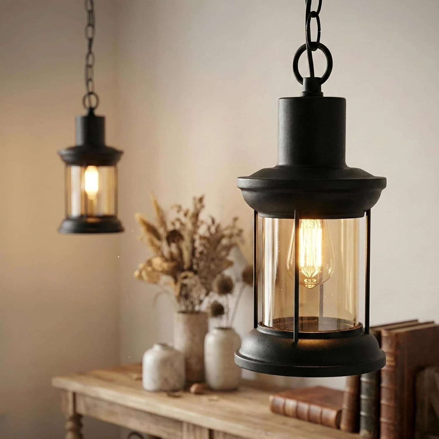 Two hanging lantern-style lights on a wooden surface with a neutral background