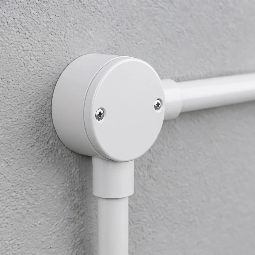 white round angle junction box on a conduit run on a grey wall